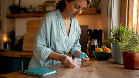 Woman collecting urine sample at home bathroom