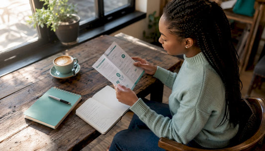 Woman reading sexual health pamphlet at kitchen table