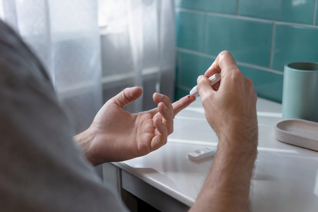 Hands preparing hepatitis C fingerprick rapid test