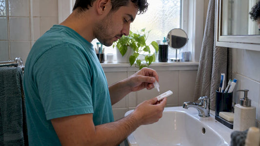 Person using an oral-fluid HIV self-test at home