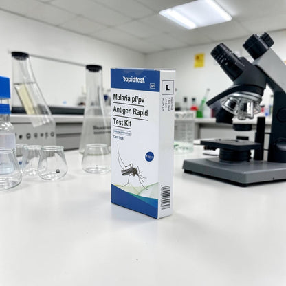 Malaria test kit box on a laboratory counter with a microscope in the background - rapidtest.co