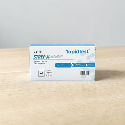 Rapidtest Strep A antigen rapid test kit box on a wooden surface with a gray background